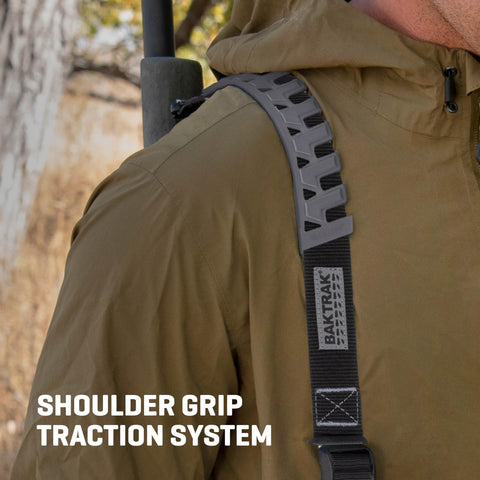 Close-up of Baktrak Traction Web Rifle Sling 36 Inch With 500Lb Rated Swivels And Slim Non Slip Pad Black And Gray on shoulder