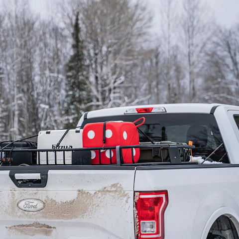 High Roller Foam Archery Target Cube With 21 Bullseyes, 13 Inch by 13 Inch, on a truck bed in snowy landscape