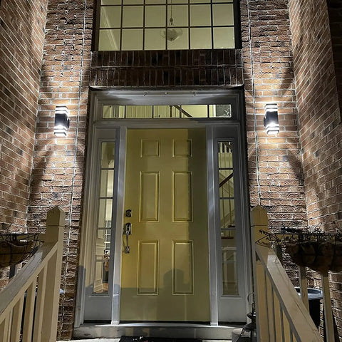 Slick Modern Black Outdoor Wall Light Two Pack Weatherproof Exterior Sconce illuminating brick entryway