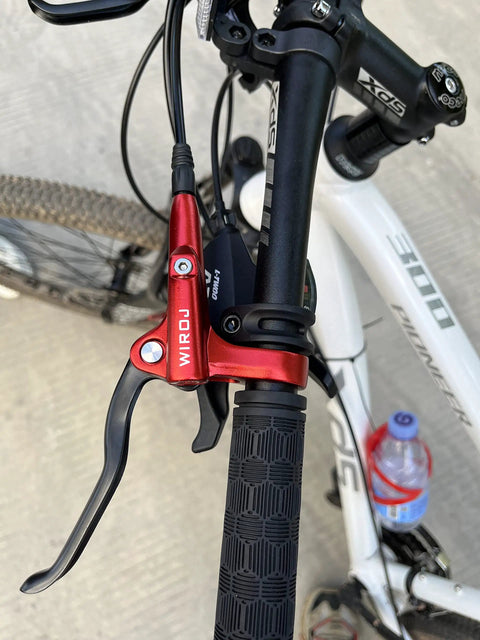 Sick Stopping Power Hydraulic Disc Brake Set For Mountain Bikes Includes Dual 160mm Rotors Long Oil Lines And Front Rear Levers close-up of red brake lever on mountain bike handlebar.