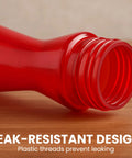 Close-up of red hummingbird feeder pinch waist design showing plastic threads, leak-resistant, 8 ounce capacity outdoor use