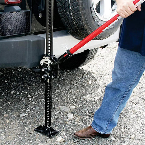 Person using Ratcheting Off Road Utility Farm Jack 33 Inch For Lifting Pulling Clamping And Winching 3 Ton 6000 Lb Capacity Red