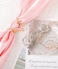 Two Piece Horse Bit Buckle Set Silk Scarf Buckle with gold and silver snaffle bit on pink silk background