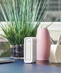 Ultra Fast DOCSIS 3.1 Cable Modem With Dual 1Gbps Ethernet Ports No Fuss Plug And Play Setup For Xfinity Cox Spectrum Works With Plans Up To 2Gbps Modem Only Router Required next to plant and vase on desk