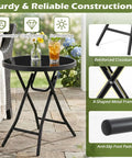 Compact Outdoor Folding Side Table With Tempered Glass Top And Heavy Duty Steel Frame For Backyard Hangouts showcasing stable design and drinks.