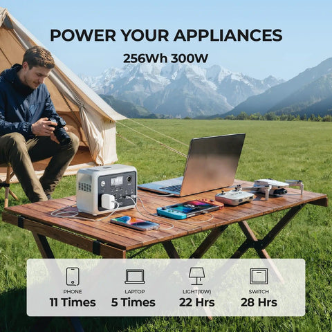 On The Go Portable Power Station 300W 256Wh Solar Generator on table during camping with laptop and phone charging outdoors