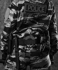 Heavy Duty Door Jam Blocker for First Responders and Police Tactical Crews shown on officer in camo uniform with gear