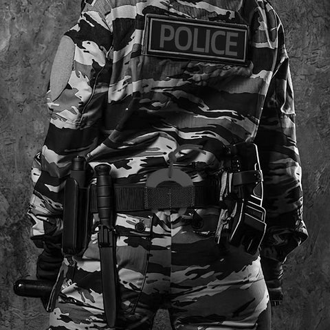 Heavy Duty Door Jam Blocker for First Responders and Police Tactical Crews shown on officer in camo uniform with gear