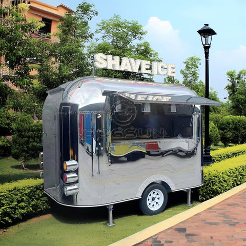 Premium Polished Mirror Food Trailer With Fold Down Awning And Stainless Steel Counter Space For Concession Operators And Mobile Coffee Shops Solid Gear To Crush Sales Daily, side view in a garden setting.