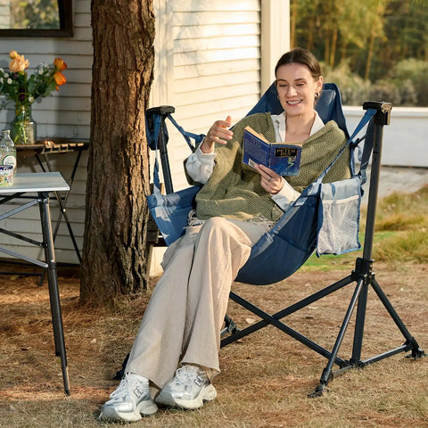 Person relaxing in a Heavy Duty 400 Lb Hammock Camping Chair With Adjustable Recline And Headrest Pillow, blue color outdoors