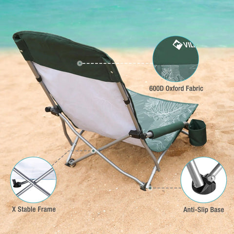 Low Beach Chair With High Back Foldable And Lightweight For Outdoor Use Great For Beach Camping Lawn And Festivals Includes Cup Holder And Carry Bag Ergonomic Back Support Durable 600D Fabric In Vintage Green Leaves on sand