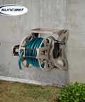 Wall Mount Hose Reel With Storage Tray Space Saving For Five Eighth Inch Vinyl Hose 175 Foot Capacity Outdoor Organizer In Dark Taupe To Keep Your Yard Neat And Hoses Easily Accessible mounted on wall with green hose.