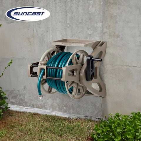 Wall Mount Hose Reel With Storage Tray Space Saving For Five Eighth Inch Vinyl Hose 175 Foot Capacity Outdoor Organizer In Dark Taupe To Keep Your Yard Neat And Hoses Easily Accessible mounted on wall with green hose.