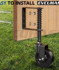 Top Shelf 4 Inch Spring Loaded Gate Caster Wheel With Side Brake And 360 Degree Swivel For Outdoor Wooden Fence Gates Heavy Duty Rig Built Like A Tank To Roll Smooth Over Bumps Black Pair mounted on wood with spring mechanism.