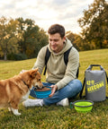 Man feeding dog with collapsible bowl from 10L Dog Food Travel Bag With Collapsible Bowls For On-The-Go Kibble, 42 Cup Capacity