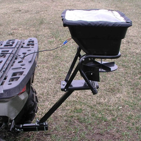 12V Grass Seed And Fertilizer Spreader With 80 Pound Capacity Hitch Mount Receiver on ATV, featuring heavy-duty 12V DC motor.