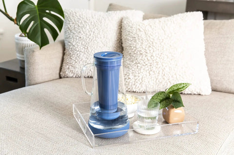 Water Filter Pitcher 7 Cup Glass With Silicone Base Stormy Blue Removes Bacteria Parasites Microplastics Lead Mercury PFAS And A Range Of Chemicals For Everyday Tap Water Protection on a tray