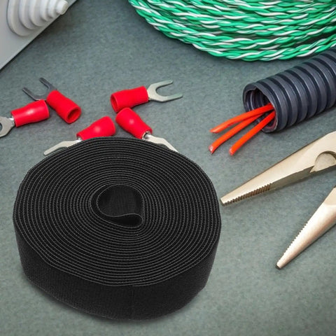 Adjustable Reusable Hook And Loop Cable Ties For Superior Desk Wire Management And Phone Charger Cord Organizing To Keep Your Tech Setup Snazzy And Totally Tidy, round black velcro straps on a work surface.