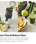 Hurom H70 Cold Press Juicer Easy To Clean Masticating Slow Juicer with leafy greens and juice glasses on countertop.