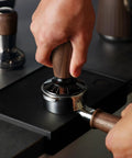 Pro Grade Digital Espresso Tamper nails your perfect 58Mm puck with solid walnut grip, adjustable force gauge display in use.
