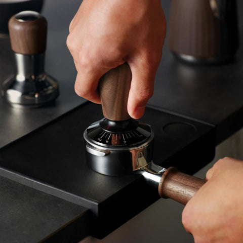 Pro Grade Digital Espresso Tamper nails your perfect 58Mm puck with solid walnut grip, adjustable force gauge display in use.