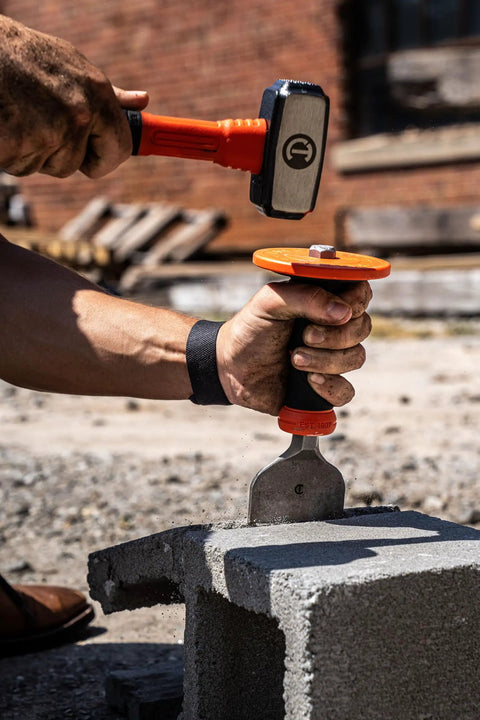 3 Inch Brick Chisel With Heavy Duty Hand Guard For Masonry Projects in use on concrete block