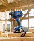 18V 1/4 Inch Hex Impact Driver Kit With 2Ah Battery on wooden beam in construction site