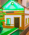 Miniature house decorated with 12V LED Lights Kit With 220 Pieces, green-lit roof, 3mm multicolor diodes for home decor.