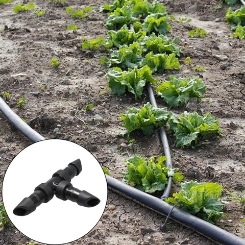 60 Pack 1/4 Inch Barbed Tee Fittings For Drip Irrigation Systems End Plug Connectors installed in a vegetable garden