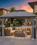Backyard Party Ready 11x13 Foot Outdoor Gazebo With LED Lights And Bluetooth Speaker Heavy Duty Metal Frame Double Roof Layer Soft Top Canopy Netting And Curtains For All Season Shade Gray, shown with patio furniture under sunset.