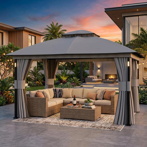 Backyard Party Ready 11x13 Foot Outdoor Gazebo With LED Lights And Bluetooth Speaker Heavy Duty Metal Frame Double Roof Layer Soft Top Canopy Netting And Curtains For All Season Shade Gray, shown with patio furniture under sunset.