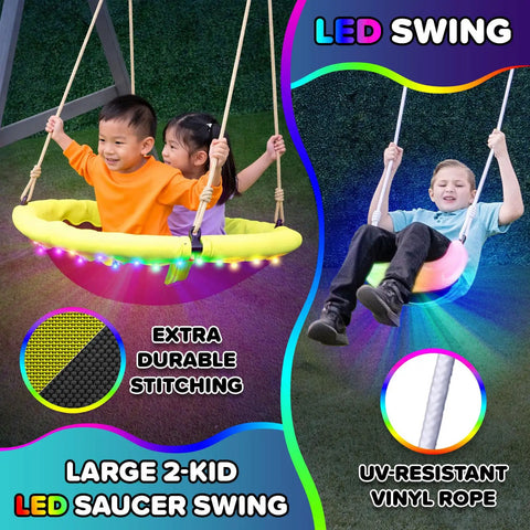 Children playing on Cedar Wood Swing Set With Nighttime LED Swings And Slide, 2 Person LED Saucer Swing, in backyard.