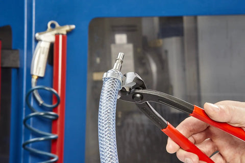 Close-up of 10 99 I220 Ear Clamp Pliers With Front And Side Jaws For One Ear And Two Ear Clamps on a hose