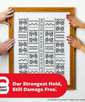 Persons hanging picture with Heavy Duty Picture Hanging Strips XL 20Lb Capacity 10 Pairs 20 Strips Damage Free Hangers.