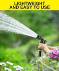 FOXEASE 25 ft stainless steel garden hose with spray nozzle in use outdoors by a child watering flowers