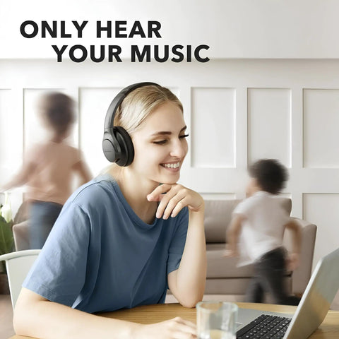Woman using All Day Wireless Over Ear Headphones With Active Noise Canceling, 60 Hour Battery Life, Hi Res Audio indoors.