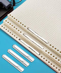 Heavy Duty Self Adhesive Ring Binders With Solid Steel Fasteners securing graph paper for organized file management.