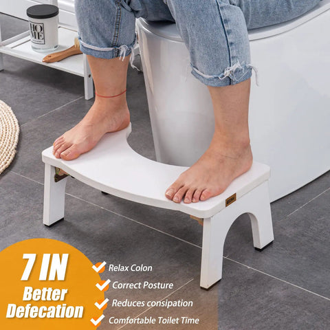 Wooden Toilet Stool For Adults Foldable 7 Inch Squat Poop Stool With Anti Slip Feet in Pure White shown in use in bathroom.