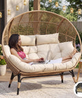 Woman relaxing on Oversized Double Egg Chair For Indoor And Outdoor Use With Thick Padded Cushions Two Seater Loveseat on patio
