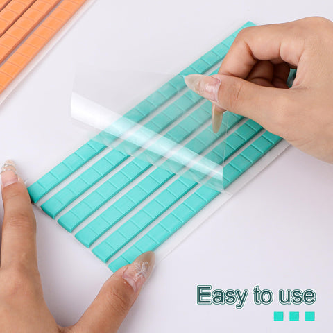 Hands peeling sheet of Blue Poster Putty Adhesive Reusable And Removable Sticky Tack For Wall Art And Photos 120 Pre Cut Squares