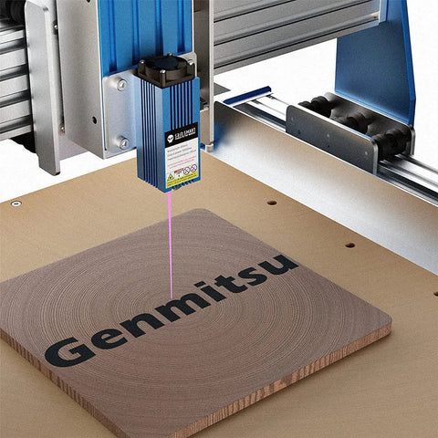 5.5W Fixed Focus Laser Module Kit engraving wood on CNC router with Genmitsu branding, 20mm fixed focus distance visible