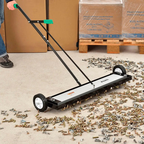 Built Different Heavy Duty 36 Inch Floor Magnetic Sweeper With Quick Release Lever For Warehouses And Shop Floors Picks Up Steel Scrap And Hardware Cleanup Rocks on workshop floor collecting screws and nails.