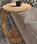 C Shaped End Table On Wheels For Small Spaces beside sofa with wood finish and coffee cup on top