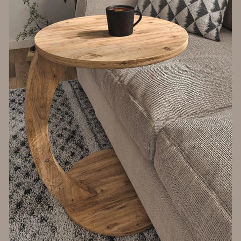 C Shaped End Table On Wheels For Small Spaces beside sofa with wood finish and coffee cup on top