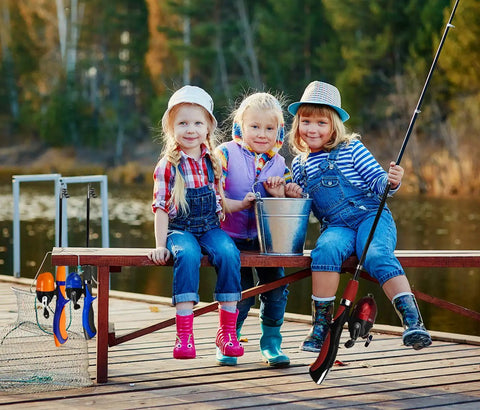 Kids enjoying fishing by a lake with Kids Telescopic Fishing Pole And Reel Combo With Tackle Box Easy Open Starter Kit.