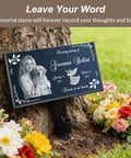 Natural Black Granite Headstone Grave Marker With Personalized Engraving resting against tree with flowers