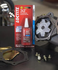 Medium Strength Surface Insensitive Threadlocker For 1/4 To 3/4 Inch Fasteners on a table with automotive parts