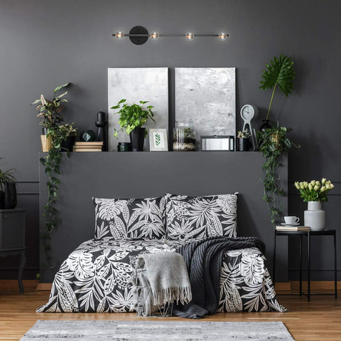 Monroe 4 Light Slim Profile Track Lighting Matte Black Finish with adjustable heads illuminating a minimalist bedroom space.
