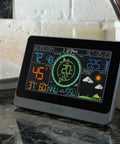 Pro Grade Wireless Color Weather Station With Cyclone Sensor And Atomic Time Display showing temperature, wind speed, and forecast