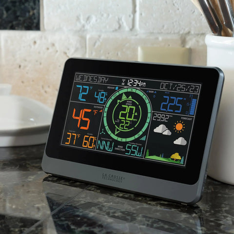 Pro Grade Wireless Color Weather Station With Cyclone Sensor And Atomic Time Display showing temperature, wind speed, and forecast